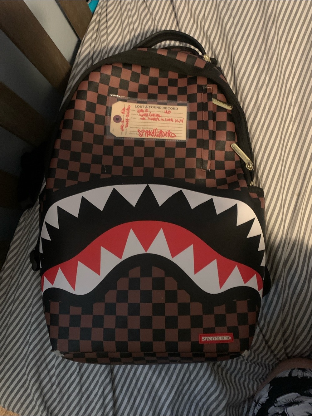 Sprayground Brown and Black Checkerboard Shark Backpack with Red Accent